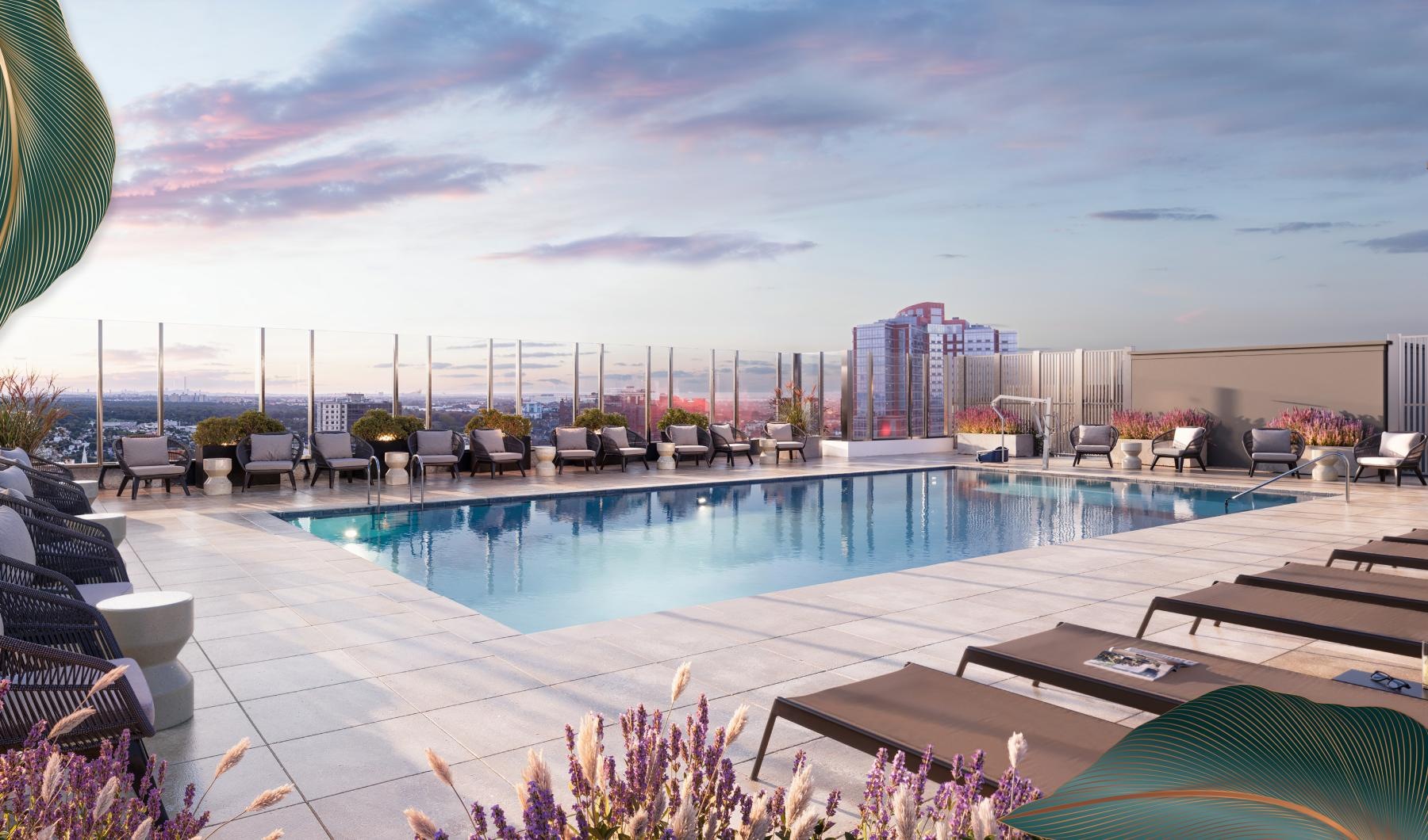 Settle into comfort at The Leaf The rooftop pool at The Leaf apartments in New Rochelle, NY, featuring lounge chairs and a view of the city.
