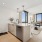 Designer one-bedroom apartment at The Leaf featuring a gourmet kitchen with quartz countertops and stainless steel appliances.