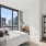 Bright and airy two-bedroom apartment at The Leaf featuring floor-to-ceiling windows and stunning city views.