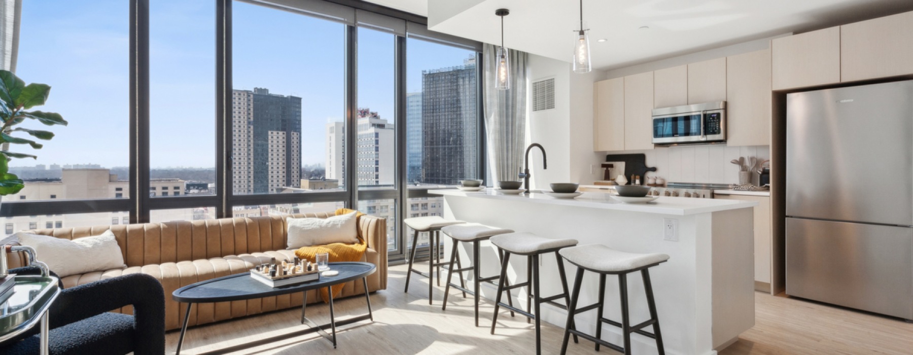 Kitchen with island, bar stools, and a couch.