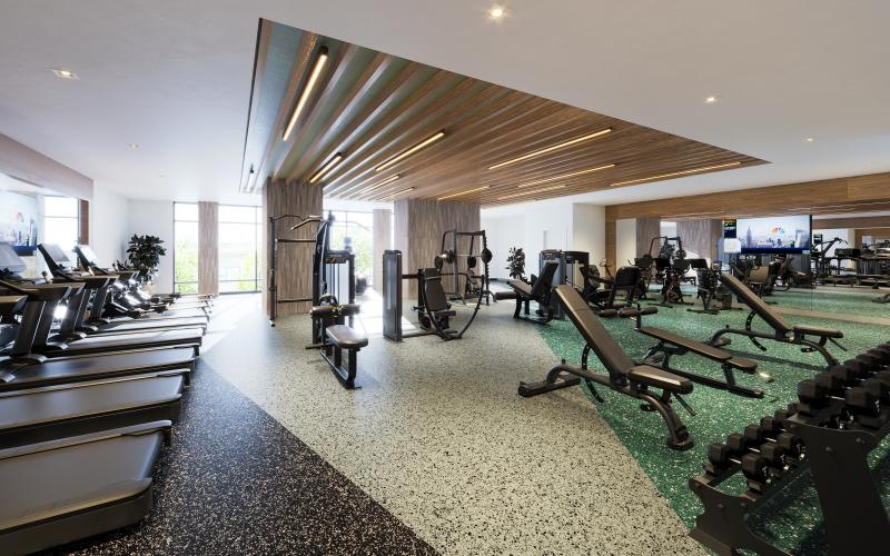 a room with exercise equipment and chairs