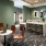 Co working space and lounge at The Leaf apartments in New Rochelle, NY, featuring counter seating and green walls.